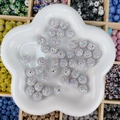 Perles boule disco en cristal AB pour bijoux DIY présentées dans un plat en céramique - Rond (12mm) / Blanc Aurore AB