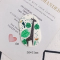 Macro detail of acrylic oval giraffe and toucan charm with tropical leaves pattern - Giraffe And Toucan Oval Style