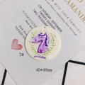 Detail of round acrylic unicorn charm with floral wreath and perforation for DIY jewelry - Purple Unicorn Round Style