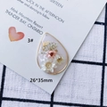 Macro shot of 26x35mm teardrop resin pendant with dried flowers, gold leaf and butterfly - Large Teardrop Gold Butterfly Style (3#)
