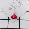 Macro view of a dark red fabric petal charm with pearl and golden filigree cap - Dark Red
