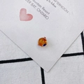 Close-up of orange translucent glass evil eye bead pendant on white decorative card - Evil Eye Sphere Style (3#)