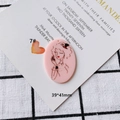 Detail view of a 39x41mm pink acrylic oval charm with hand-drawn female portrait and top hole - Vintage Hat Woman Portrait (7#)