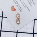 Macro detail of infinity gold-plated connector with bowknot and white cubic zirconia - Transparent White Style (1#)