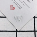 Close-up of translucent white acrylic butterfly pendants with pearlescent wing textures - Pearlescent White (2)