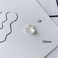 Macro view of 13mm white acrylic flower beads with central hole for DIY jewelry making - Three-petal Bud Shape (5#)