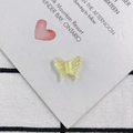 Detailed macro of translucent butterfly resin charms with subtle glitter for jewelry making - Light Yellow (9)
