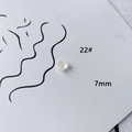 Detailed macro view of a 7mm white acrylic flower bead with delicate textured petals - Tiny Petal Shape (22#)