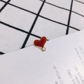 Detail of red enamel heart-shaped charm with gold metal trim and ring for DIY jewelry making - Brown