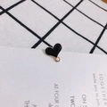 Macro detail of heart-shaped black oil drip pendant with golden metal edge for DIY jewelry - Black
