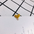 Close-up of heart-shaped yellow enamel pendant with gold-plated DIY jewelry ring - Yellow