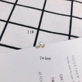 Close-up of a 7x4mm round pearl pendant with a gold metal loop, accessory number 11 - 7x4mm Mini Pearl Pendant (11#)