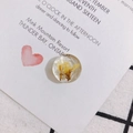 Detailed view of round resin floral pendant with yellow dried flowers and faceted surface - Natural Yellow Dried Flower Inlaid Style