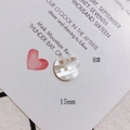 Close-up of 15mm shell button with checkered inlay and iridescent finish on white card - Iridescent Luster Round Grid Splicing (8#)