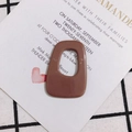 Macro detail of a brown hollow trapezoid acrylic pendant for DIY jewelry making - Coffee