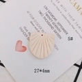 Macro detail of a 27x4mm fan-shaped cream resin charm with radial texture and pre-drilled hole - Beige Radial Texture Fan (5#)