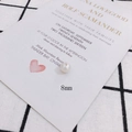 Detail shot of 8mm iridescent white pearl bead with drill hole on a white wedding card - Subtle Pearlescent Round Bead(6#)