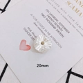 Detailed macro view of a 20mm white pleated resin flower bead for DIY jewelry making - Textured Ball/Cream Flower (4)