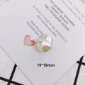 Macro view of a 19x18mm iridescent white baroque pearl bow charm for DIY jewelry making - Baroque Irregular (6)