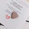 Macro view of a glossy dusty pink resin triangle charm for DIY jewelry and hair clips - Dusty Pink