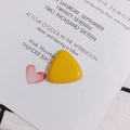 Macro detail of glossy yellow resin triangle charms for DIY jewelry and phone case crafts - Yellow