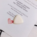 Macro view of a triangular off-white resin cabochon for DIY phone case accessories - Off White