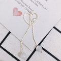 Detailed view of heart-shaped gold tassel pendant with zircon and cat's eye beads - Gold Heart Tassel Style (1#)