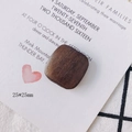 Macro detail of square brown walnut wood jewelry accessories with 25mm dimensions - Rounded Square (2#)