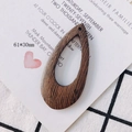 Detailed view of drop-shaped brown wooden earring pendant with natural grain 61x30mm - Teardrop Hollow Pendant (3#)