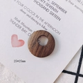 Macro detail of 25mm round dark brown wood pendant with natural grain for DIY jewelry - Round Vented Hole Pendant (11#)