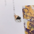 Detailed view of a clear acrylic crystal pendant with black inclusions and a gold metal cap - Transparent Black