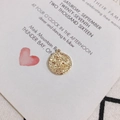 Macro detail of a 18K gold plated vintage zodiac pendant featuring a classical embossed figure - Aquarius