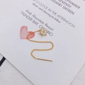 Macro shot of long gold-plated star earrings with sparkling cubic zirconia on white card - Hexagonal Star (2)