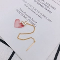 Close-up of a long golden heart threader earring with pavé cubic zirconia and a fine chain - Heart Shape (4)