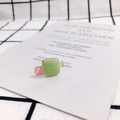 Close-up of a square light green enamel pendant with golden frame for DIY jewelry - Mustard Green