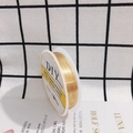 Macro detail of high-luster gold-plated copper wire on a spool for fine jewelry making - 0.2mm x 24m / Gold