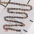 Detailed view of amber and clear acetate link chain for DIY eyewear and jewelry accessories - Style 1