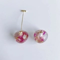 Close-up of resin cherry charms with dried flowers and gold metal stems for DIY jewelry - Pink Flower Style