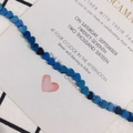 Macro shot of 6x2mm heart-shaped blue metallic hematite beads for DIY jewelry making - Blue