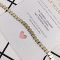 Detailed view of polished golden heart-shaped beads for DIY jewelry and beaded crafts - Dark Gray
