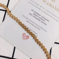 Close-up of golden matte heart-shaped chain links for jewelry making and DIY projects - Bronze