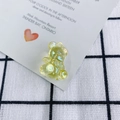 Detail of a transparent yellow acrylic bear pendant with an iridescent shimmering finish - Lemon Yellow