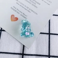 Macro shot of transparent blue AB coating aurora bear resin charm with faceted surface - AB Iridescent Green