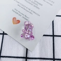 Macro shot of a purple iridescent transparent acrylic 3D bear pendant for DIY jewelry - Colorful Purple