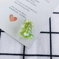 Close-up of a light green translucent teddy bear pendant with iridescent AB coating - Iridescent Green