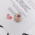 Detailed macro of vintage oval pink crystal pendant with sparkling halo on gold base - Pink