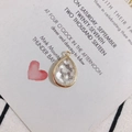 Close-up of teardrop-shaped pendant with gold metal edges and white shell fragments - White Shell Fragment (2#)