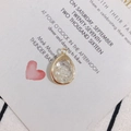 Macro detail of teardrop gold plated pendant with white pearls and miniature text - White Pearl Inlaid (8#)