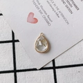 Macro view of teardrop faceted pendant with golden edges and purple dried flowers - Purple Yellow Dried Flower (10#)