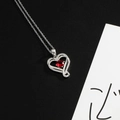 Silver heart pendant necklace with red zircon center stone and sparkling accent stones - Wine Red (July)